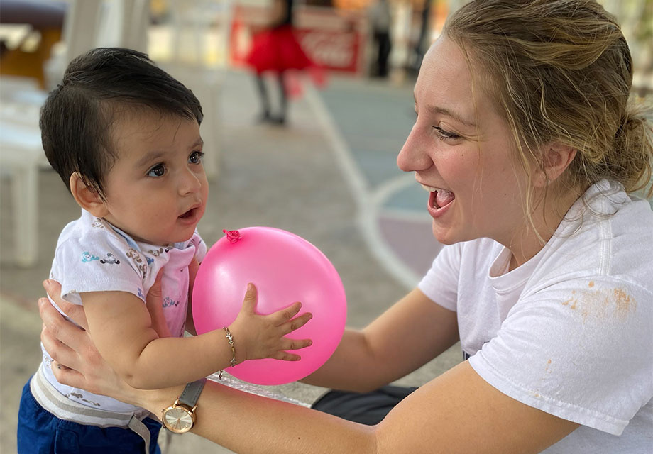 Women for DeSales, physical therapy student volunteer helping a patient on a mission trip