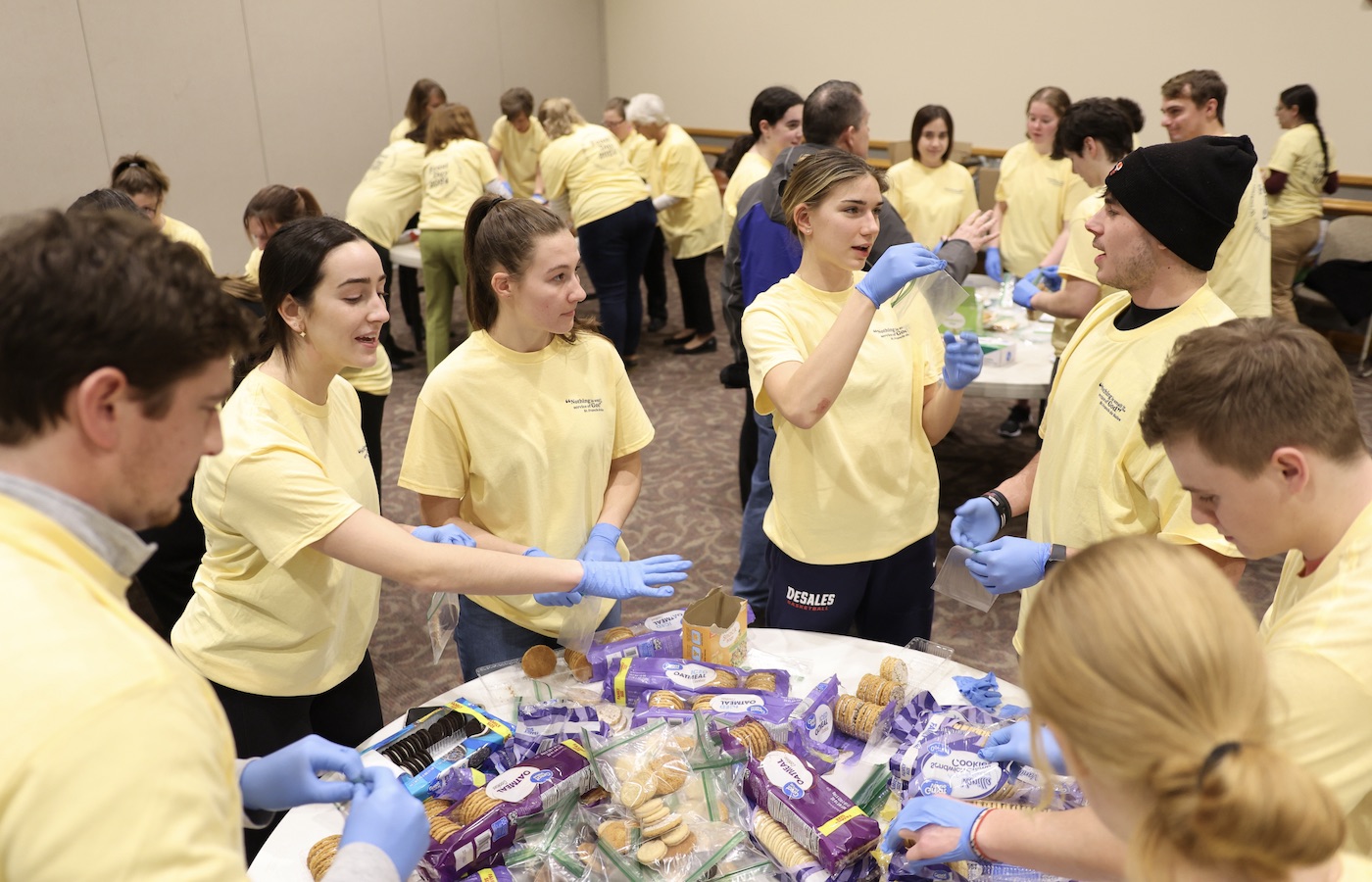 Students, faculty, and staff participating in Feast Day service project