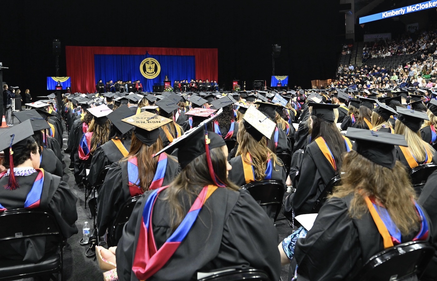 Wide shot of Commencement stage and crowd of graduates