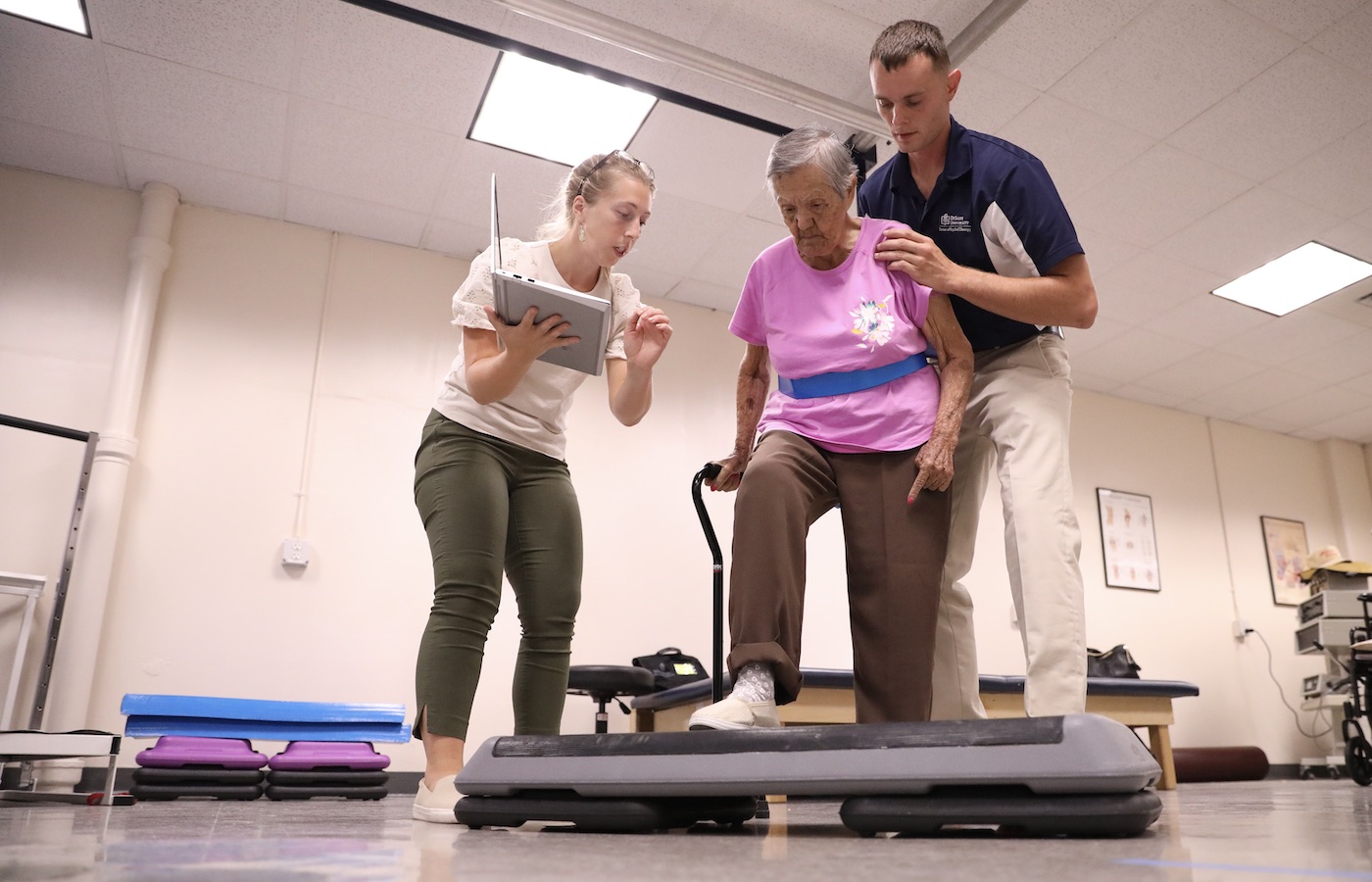 Jessica Watson and Joseph White working with a client in the DeSales Community Wellness and Physical Therapy Clinic