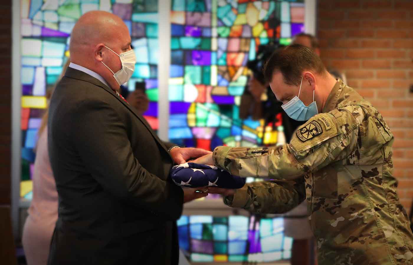 Brother of DSU alum Dan Gallagher '00, who was lost in the WTC attack of 2001, is presented with the American Flag.