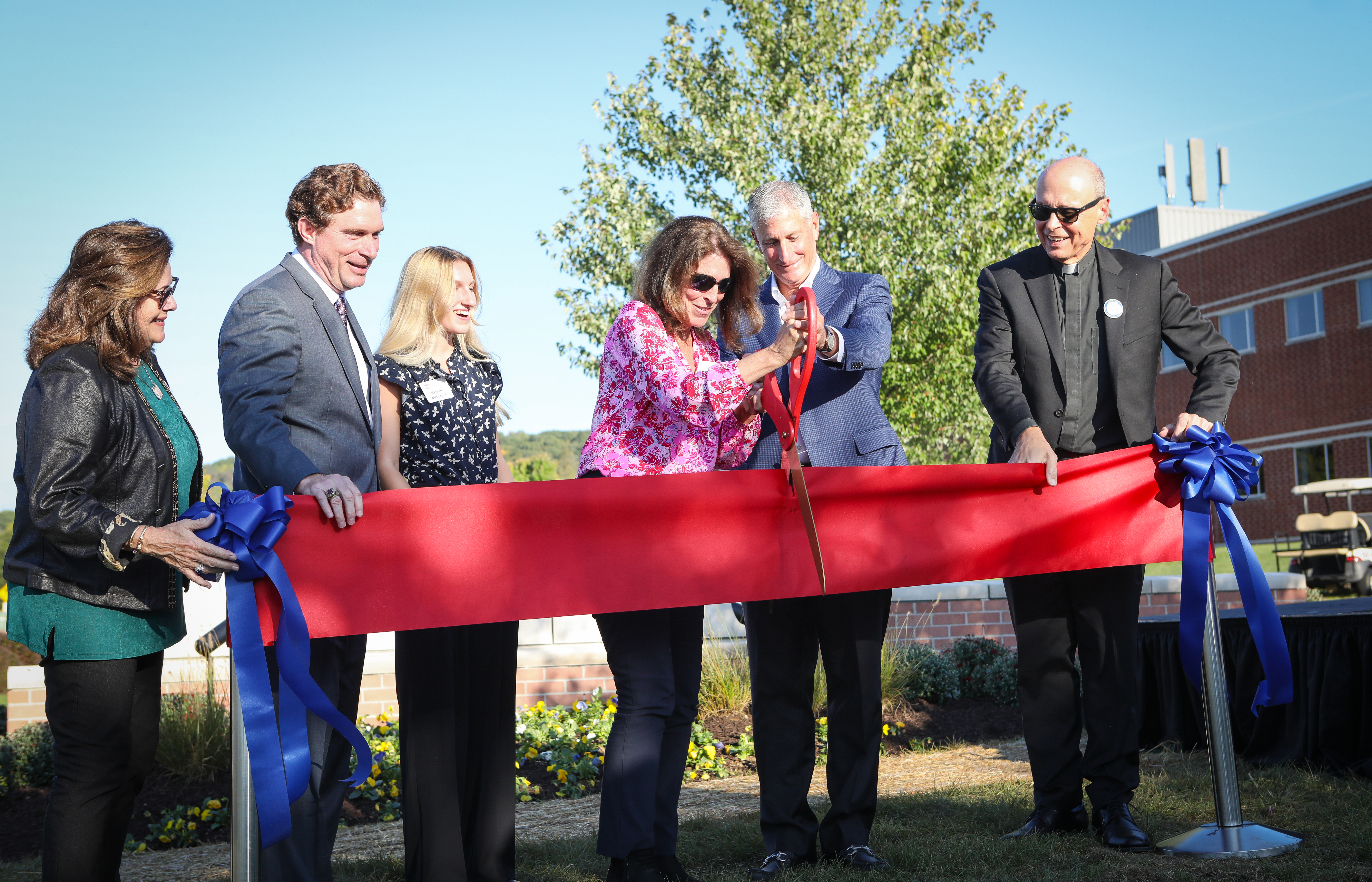 Kathleen and J.B. Reilly cutting the ribbon on the Waterbury Reilly School of Business