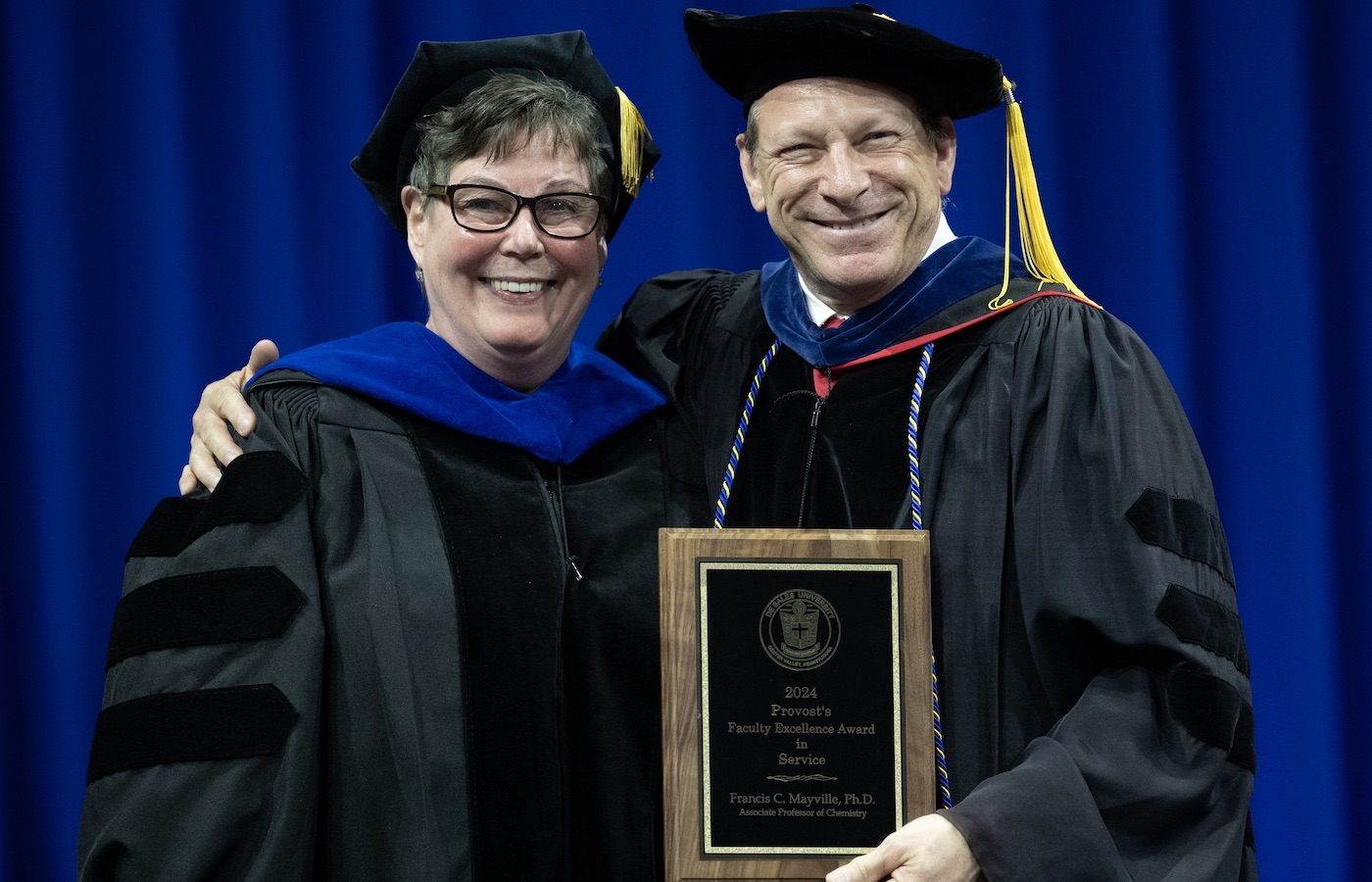 Terese Wignot and Francis Mayville on stage at Commencement